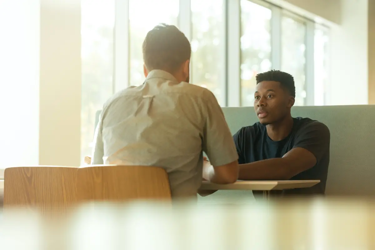 Two people in conversation at table